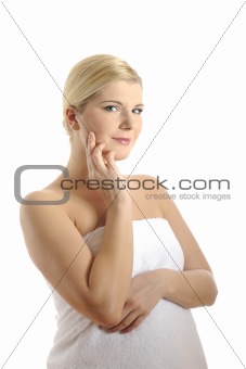 beautiful young woman in bath towel touching her skin