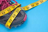 Running Shoe with Measuring Tape Health and Fitness Concept.