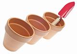 Trio of Clay Pots with Red Shovel