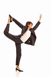 Young businesswoman in suit doing yoga Dancer Pose