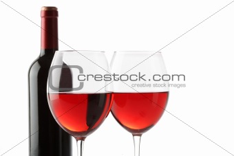 Two glasses of red wine and a bottle