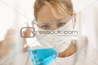 Close-up of scientist holding beaker
