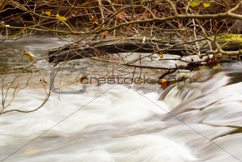 Falls on the small mountain river in a wood shooted in autumn