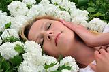 Young woman laying in flowers - snowballs