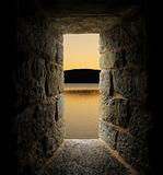 Viewing a lake or moat through a stone castle-like window