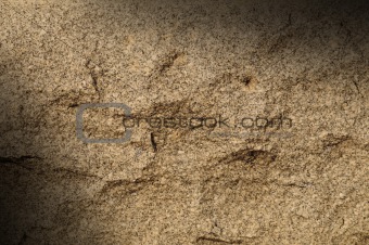Granite rock surface lit diagonally