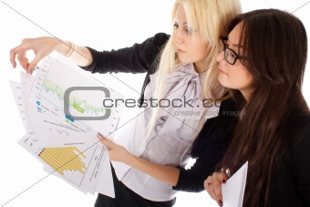 Two businesswoman looks on the graph