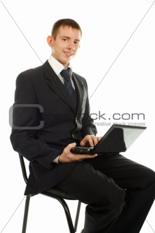The businessman on the chair with laptop