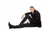 Man against sitting on a floor a white background