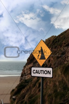 beach landslide caution sign