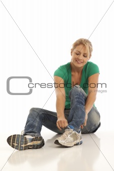 Woman tying shoe