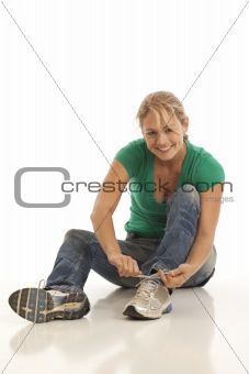 Woman tying shoe