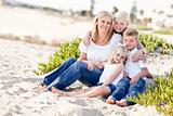 Attractive Mom Portrait with Her Cute Children at The Beach.