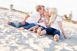 Adorable Sibling Children Kissing the Youngest Girl at the Beach.