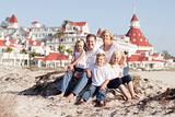Happy Caucasian Family in Front of Hotel Del Coronado on a Sunny Afternoon.
