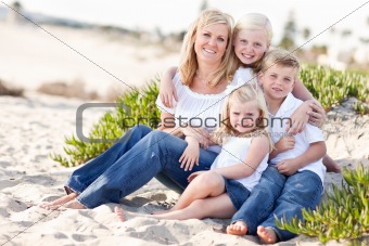 Attractive Mom Portrait with Her Cute Children at The Beach.