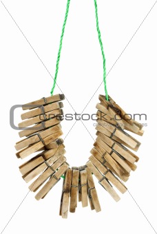Few wooden clotespins hanging on the rope