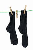Two black socks hanging on rope