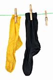 Yellow and black socks hanging on rope