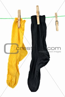 Yellow and black socks hanging on rope