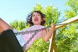 Girl swinging swing in outdoor park nature