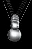 newtons cradle silver balls on black background