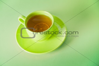 The cup of green tea with lemon