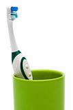 Toothbrush in a green glass