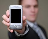 Businessman Shows Cell Phone with Shallow Depth of Field