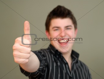 Casual Young Man Giving Thumbs Up