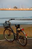 Classic bicycle parked on the seafront at sunset