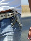 The handcuffs hanging on a belt of jeans