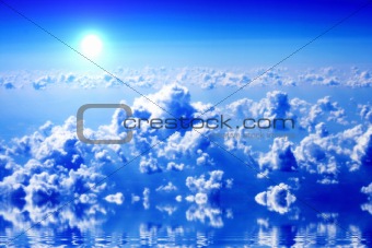 clouds and blue sky with reflections on ocean