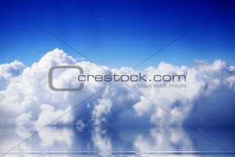 clouds and blue sky with reflections on ocean