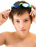 putting on goggles - small caucasian boy; in swimming goggles