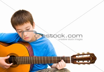 caucasian boy learning to play acoustic guitar, isolated on white background; horizontal crop