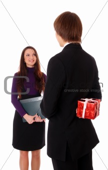 teen boy giving a gift to a girl