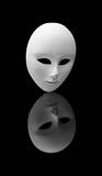 beautiful white venetian mask admiring itself in mlack mirror surface - narcissism concept