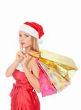 Pretty young woman dressed as Santa with shopping bags 