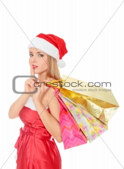 Pretty young woman dressed as Santa with shopping bags 