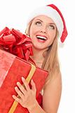 Cheerful santa helper girl with gift box 