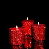 Three spangled candles in the dark