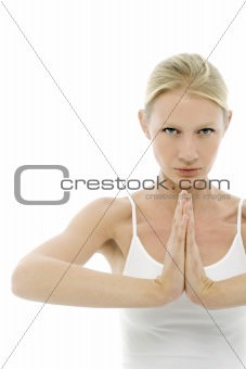 a young caucasian woman dressed in white sitting cross-legged doing yoga