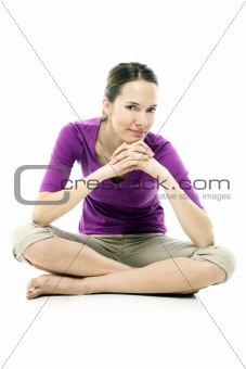 Young woman sitting on the floor on white background studio