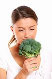Young woman smelling broccoli