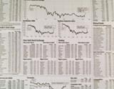 Stock Market Newspaper Background with Charts Blurred