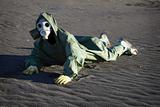 Man in gas-mask on desert ground