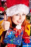 Funny girl in christmas cap with gift boxes