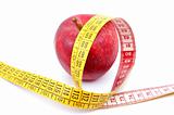 Apple and measuring tape on white