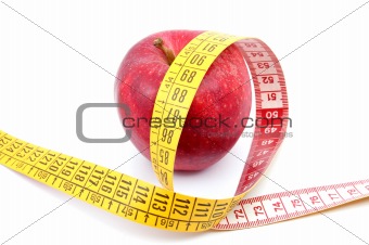 Apple and measuring tape on white